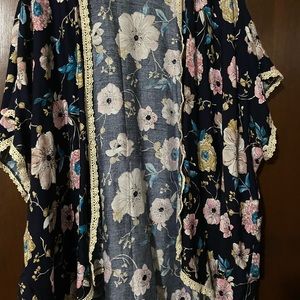 New black flowered print ruana with off white lace trim